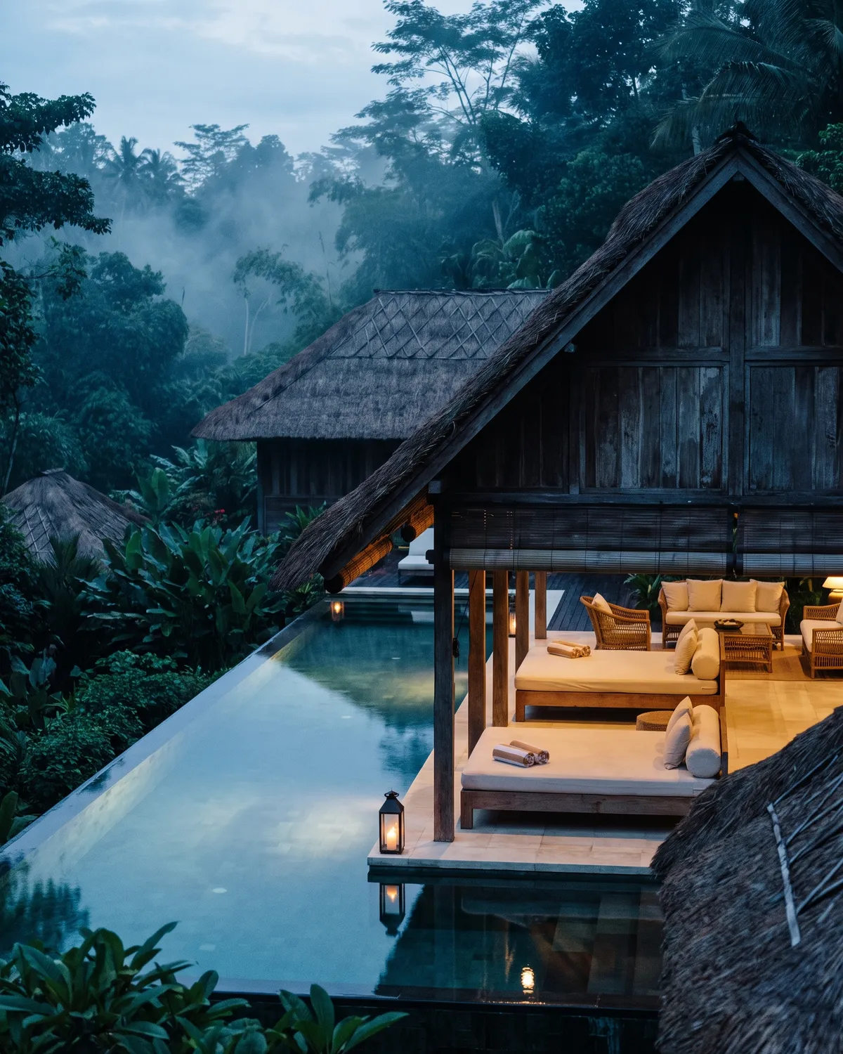 Private villa in Bali seen from the garden at first light, the open living pavilion and the pool edge in view